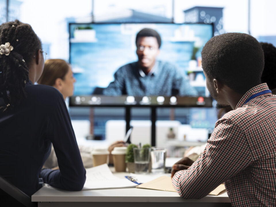 Business colleagues attend an online videocall meeting with a shareholder